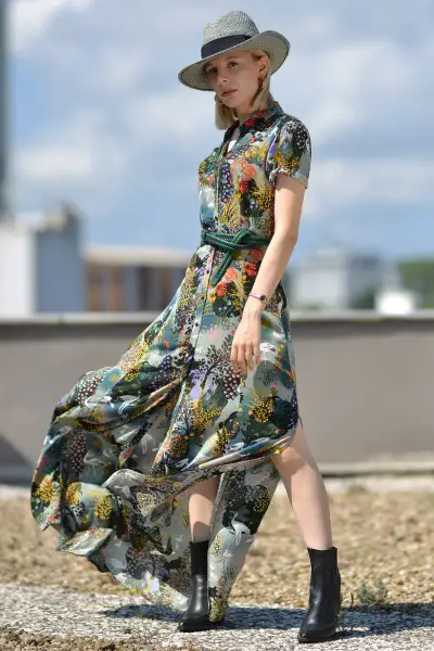 A woman wears ankle boots with split maxi dress and wide brim hat