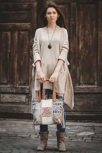 A woman wears brown cowboy boots and tunic shirt in boho style