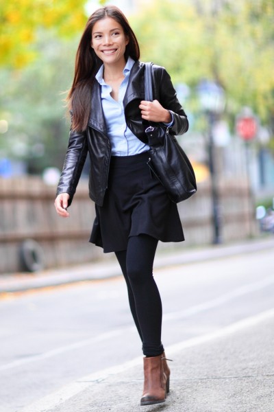 A woman wears legging with black skirt, jacket