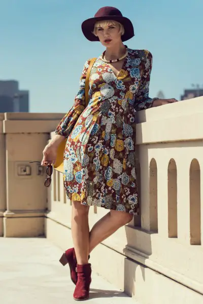 A woman wears midi dress with ankle cowboy boots and wide brim hat