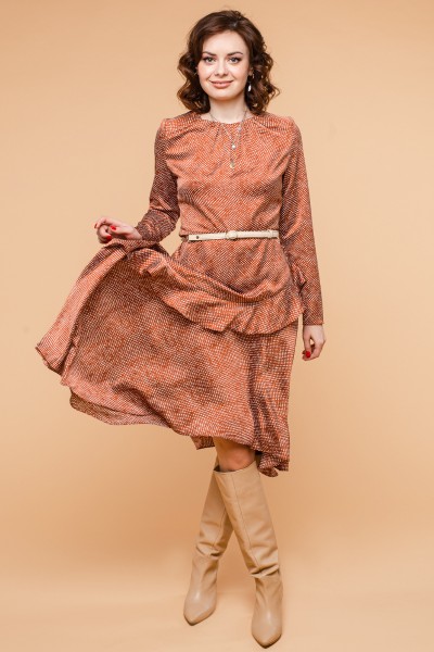 A woman wears orange long dress with cowboy boots