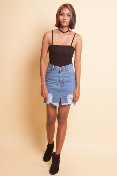 A woman wears a denim skirt 2 straps top