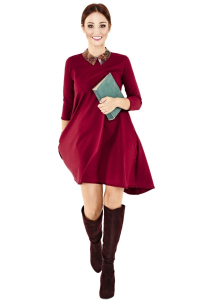 A woman wears brown boots with red dress