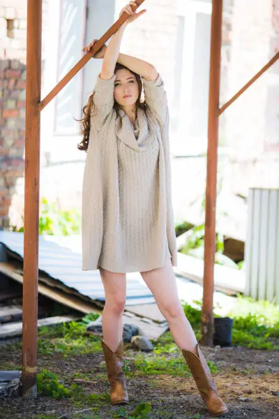 A woman wears brown cowboy boots with dress