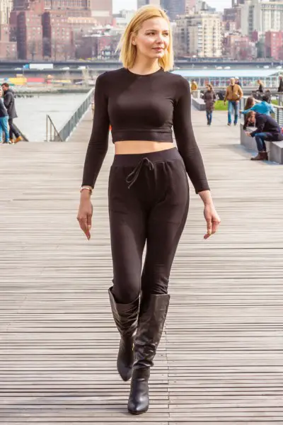A woman wears legging, boots with a fitted top