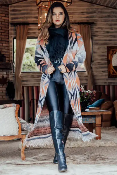 A woman wears legging, boots with black top and long coat