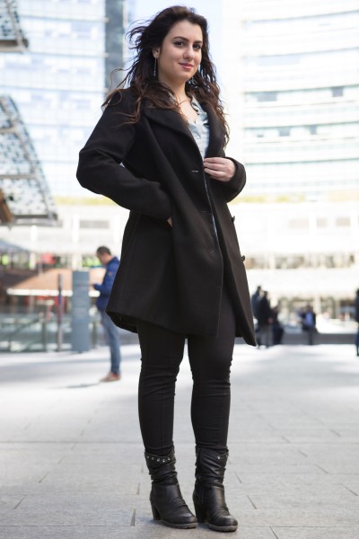 A woman wears short boots with black pants
