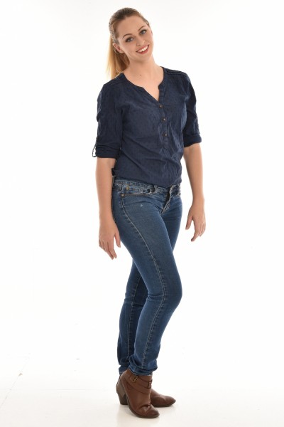 A woman wears short boots with jeans