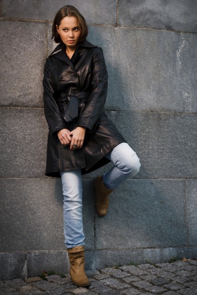 A woman wears short brown boots with jeans and leather jacket