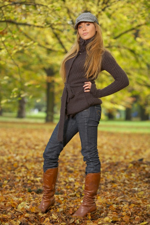 A woman wears tall cowboy boots with jeans 