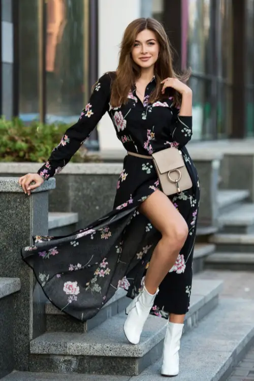 A woman wears white ankle boots with floral long dress