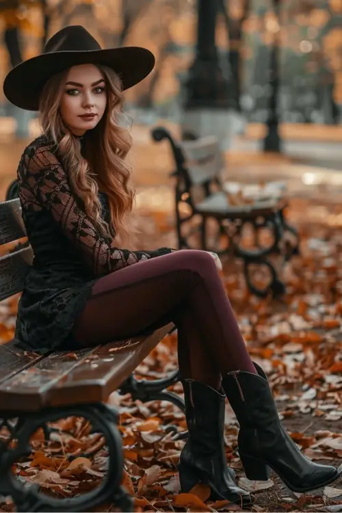 a woman wears a black dress, leggings and black cowboy boots