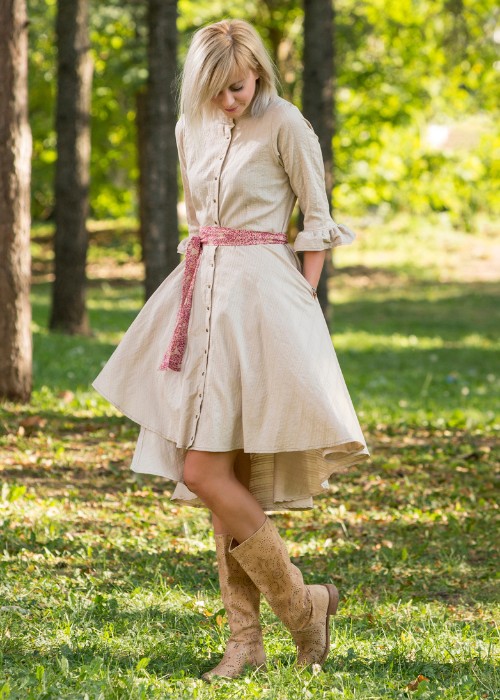A woman wears A line dress with brown cowboy boots