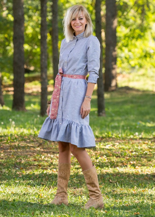 A woman wears A line dress with cowboy boots