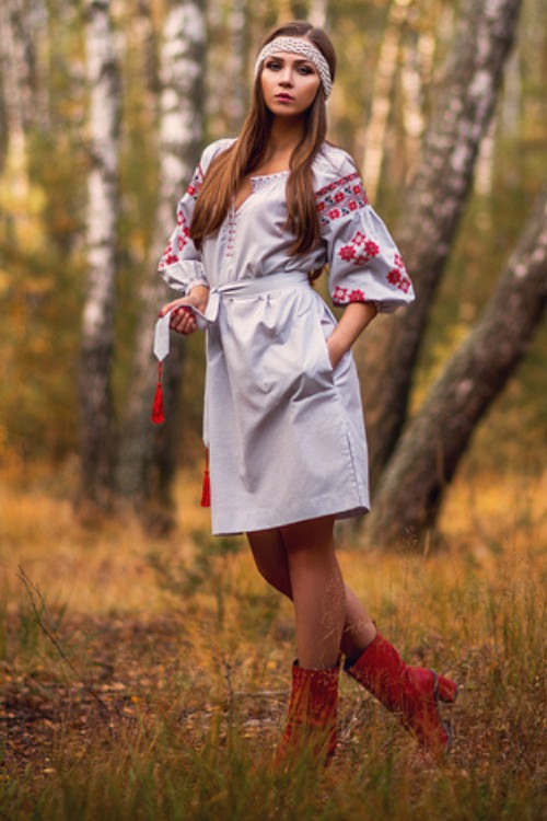 A woman wears boho dress with red cowboy boots