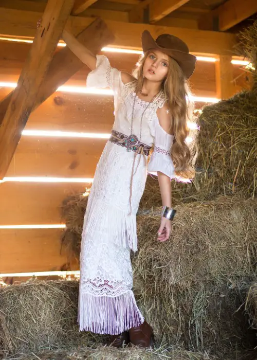 A woman wears boho maxi dress with ankle cowboy boots