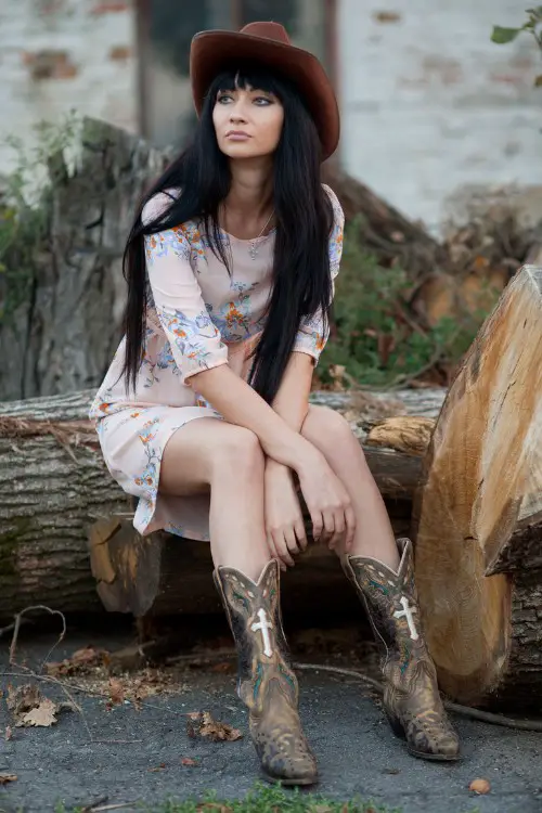 A woman wears cowboy boots with dress