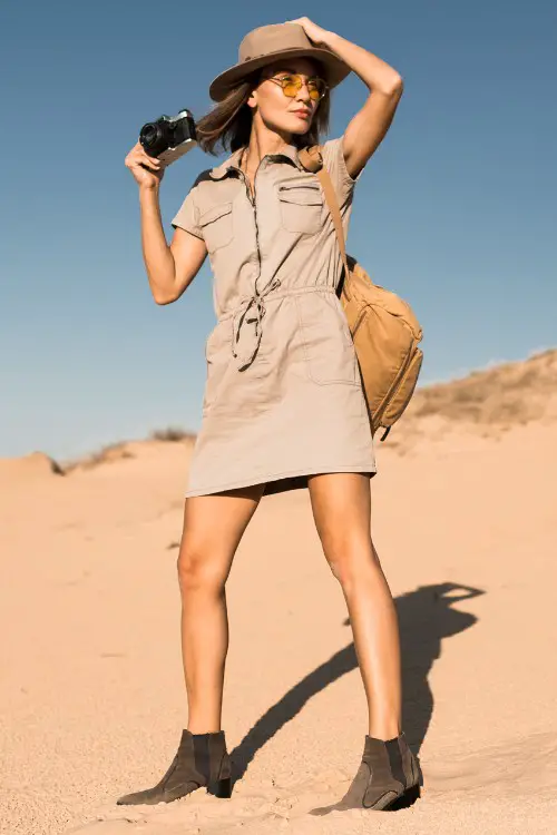 A woman wears dress shirt with brown cowboy boots