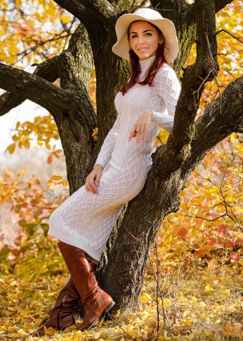 A woman wears fitted dress with ankle cowboy boots