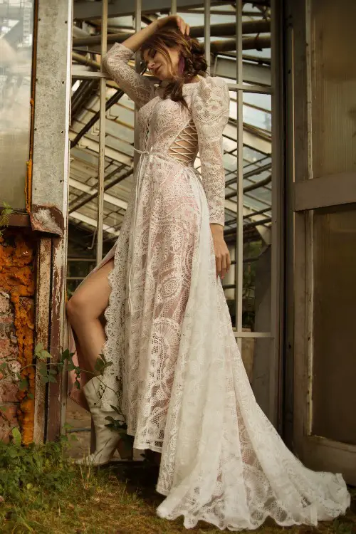 A woman wears high slit wedding dress with white cowboy boots