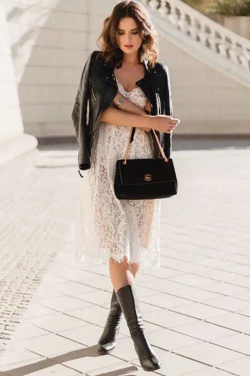 A woman wears lace slip dress with cowboy boots