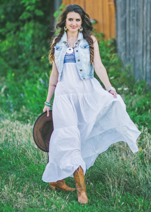 A woman wears maxi dress with ankle cowboy boots