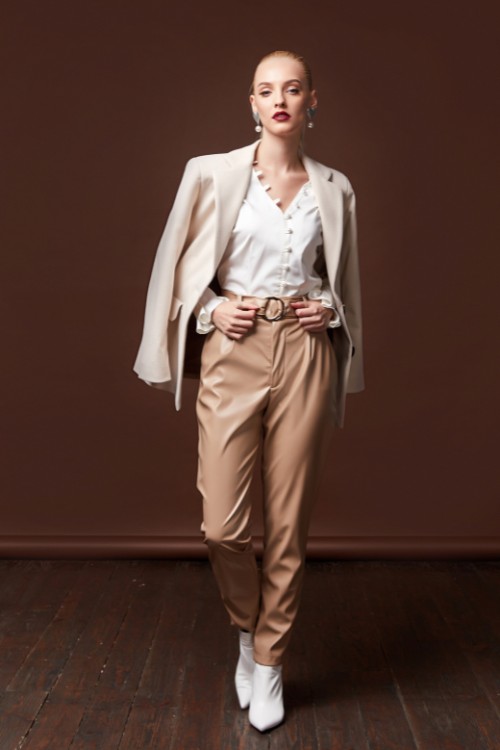 A-woman-wears-white-cowboy-boots-with-trousers-shirts-and-a-blazer