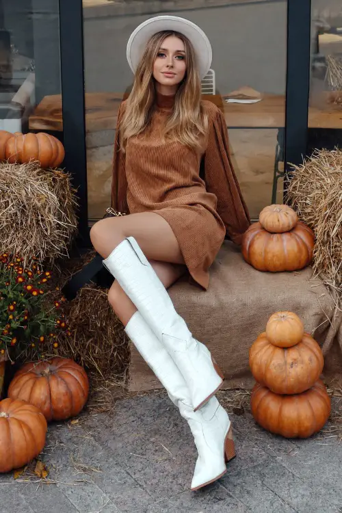 A woman wears brown dress with white cowboy boots