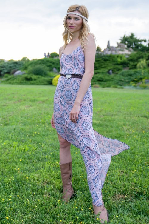 A woman wears cowboy boots with a textured dress