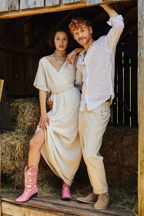 a woman wears pink cowboy boots with a white dress