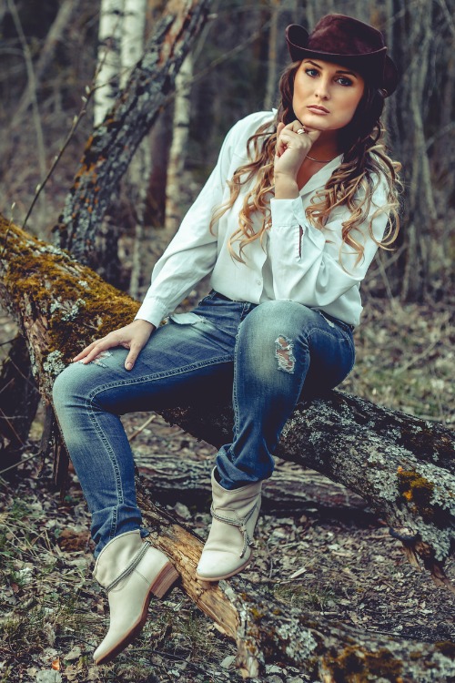A woman wears white cowboy boots with jeans and shirts