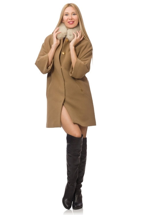 a woman wears black cowboy boots with an oversized shirt