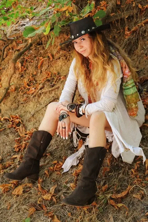 a woman wears cowboy boots with mini boho dress