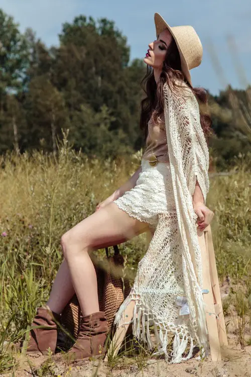 a woman wears lace shorts and cowboy boots