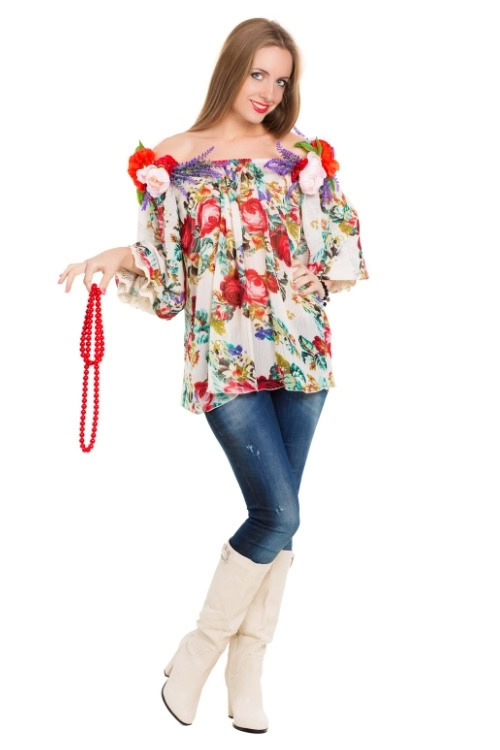 a woman wears white cowboy boots with a floral off the shoulder top