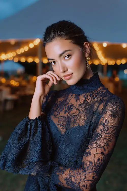 A petite woman in a navy lace midi dress with a high collar and bell sleeves