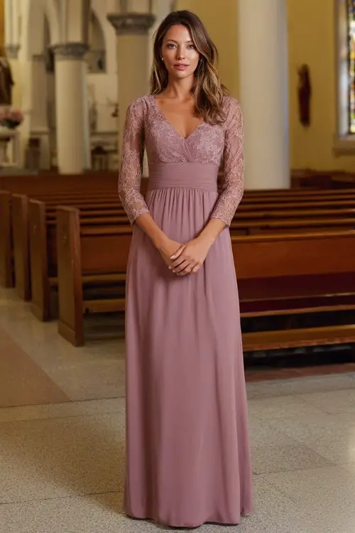 A woman wears a floor-length mauve gown with lace sleeves and a flattering empire waist