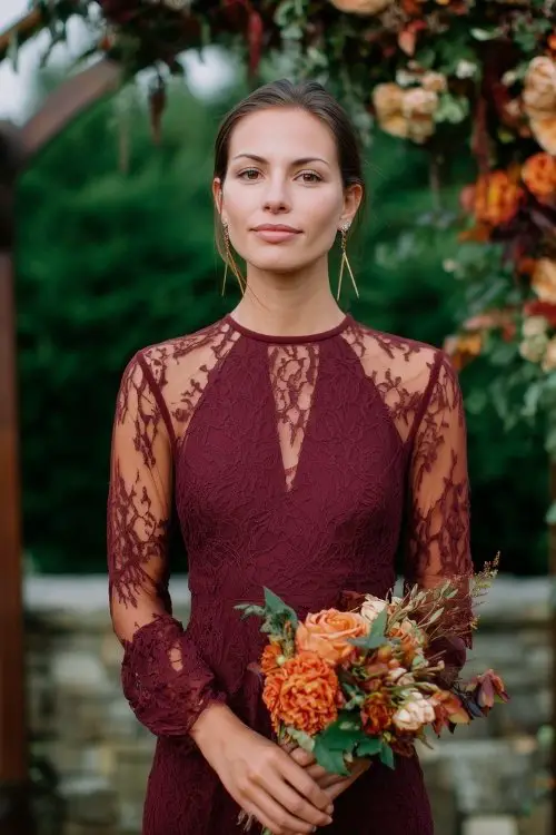 a woman wears a sheer lace burgundy wedding guest dress