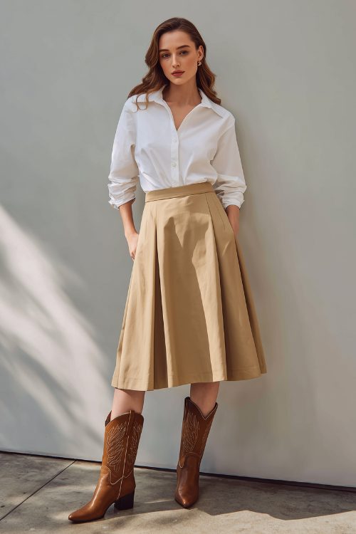 a woman wears a white shirt with tan skirt and brown cowboy boots
