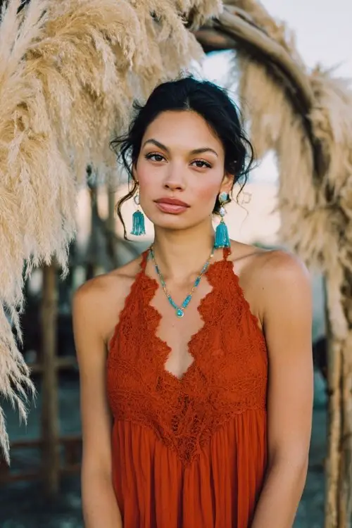 wedding guest wearing a bright colored flowy dress with lace details and turquoise jewelry