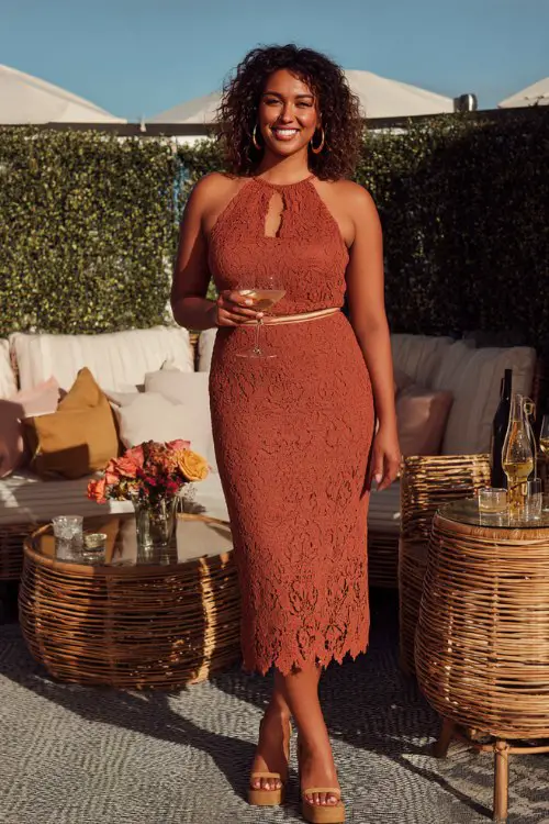 A curvy woman wears a clay-colored cotton-lace midi with a scalloped hem