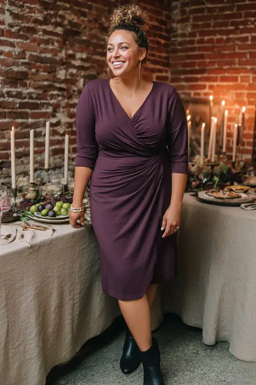 A plus-size woman over 50 wears a plum jersey midi with a twist-front bodice