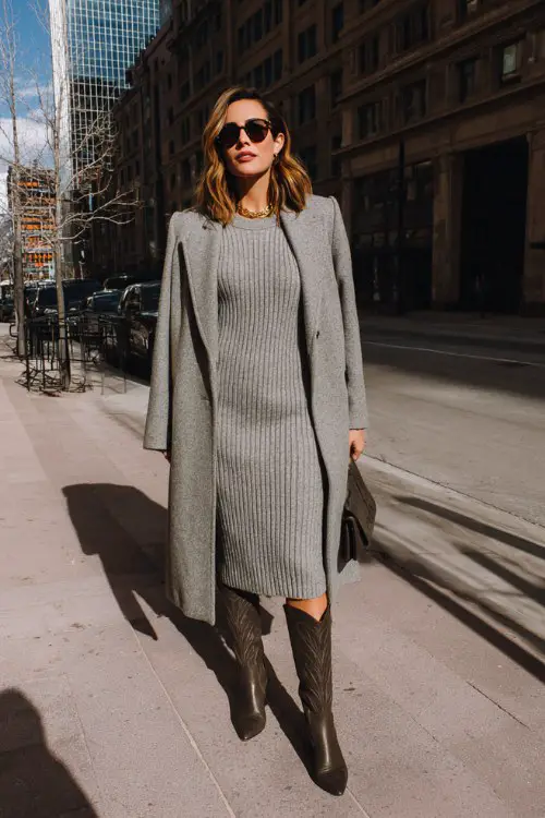 A woman over 30 wears a ribbed knit dress with pointed-toe tall cowboy boots and a longline wool coat