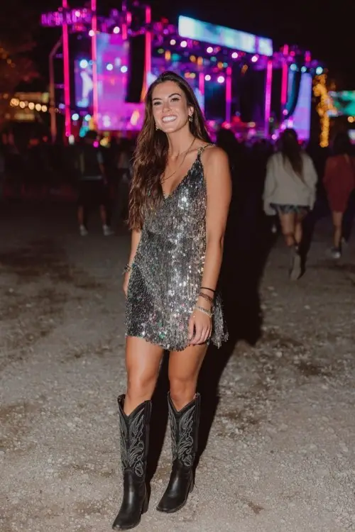 A woman over 30 wears a sequin mini dress with bold black cowboy boots (3)