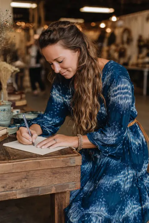 A woman wears an indigo block-print tiered midi with tassel ties and poet sleeves