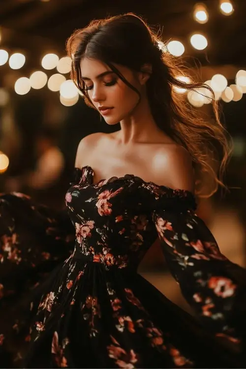 A woman wears an off shoulder black floral wedding guest dress with long sleeves