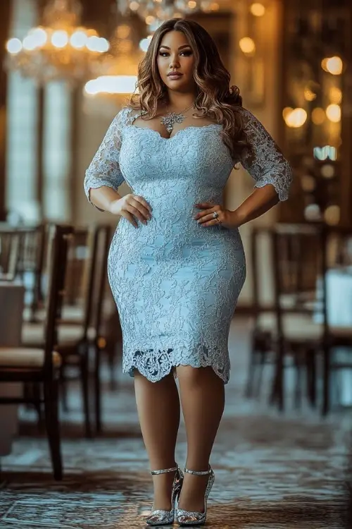 a plus size woman wears a light blue lace wedding guest dress with matching heels