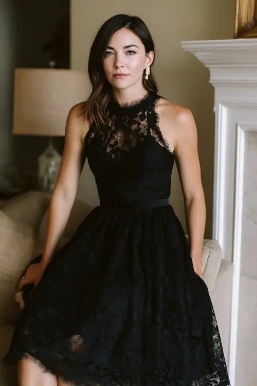 a woman over 30 in a black lace tea-length dress with satin underlay and illusion neckline