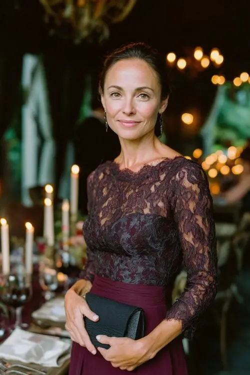 a woman over 50 in a dark plum long-sleeve gown with lace bodice