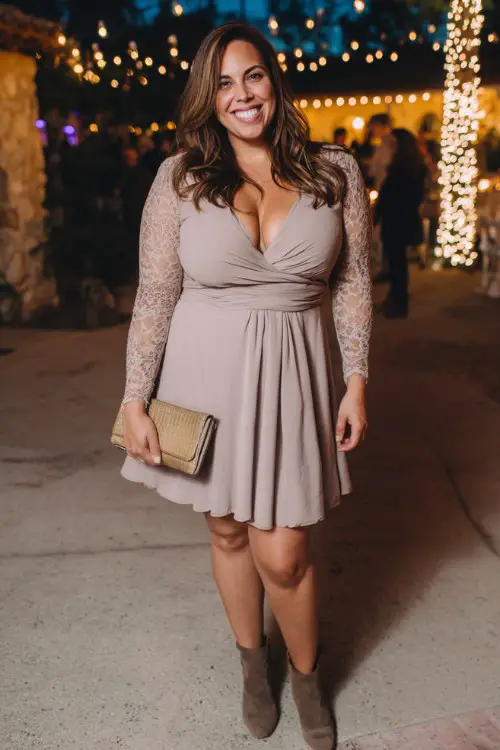 A plus-size woman wears a taupe long-sleeve fit-and-flare dress with delicate lace detailing, paired with ankle boots and a leather clutch